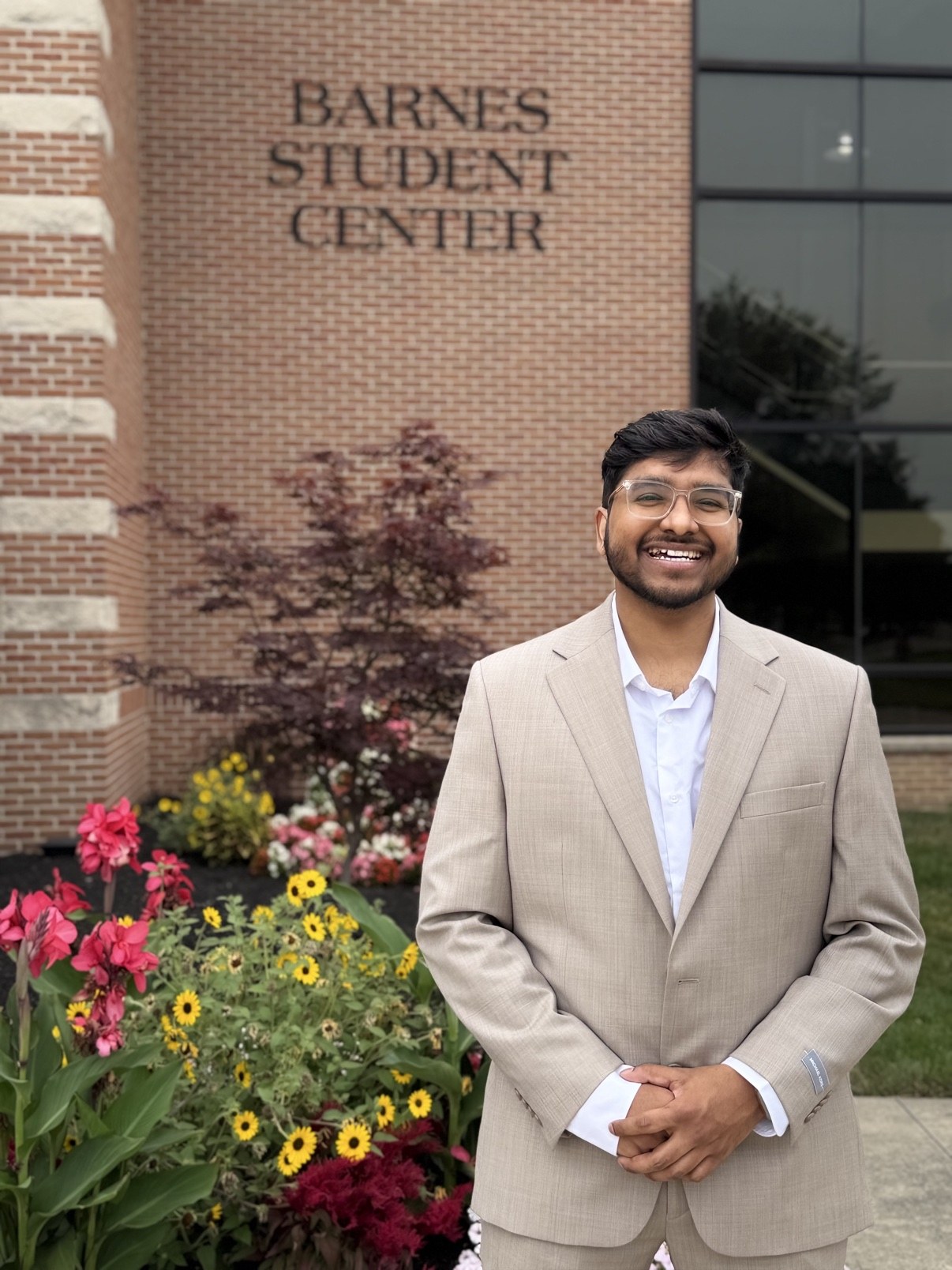 Bharath Chandra in front of the Barnes Student Center at Indiana Wesleyan University